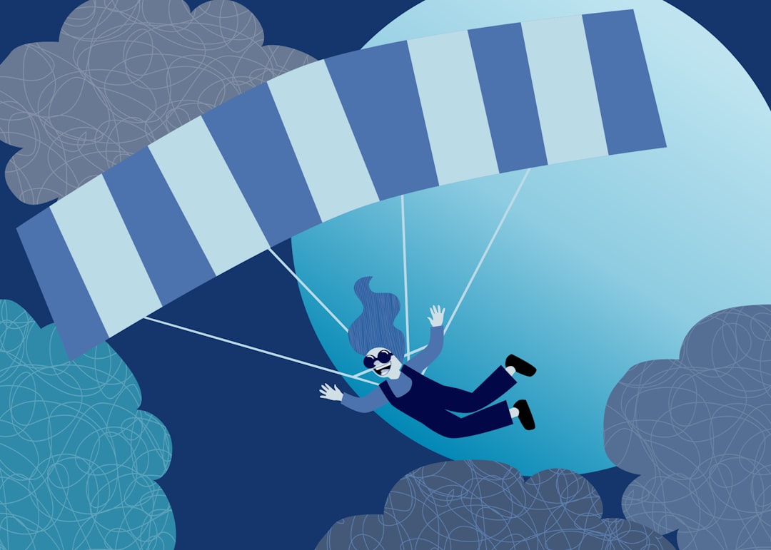 Person skydiving under a stripped parachute.